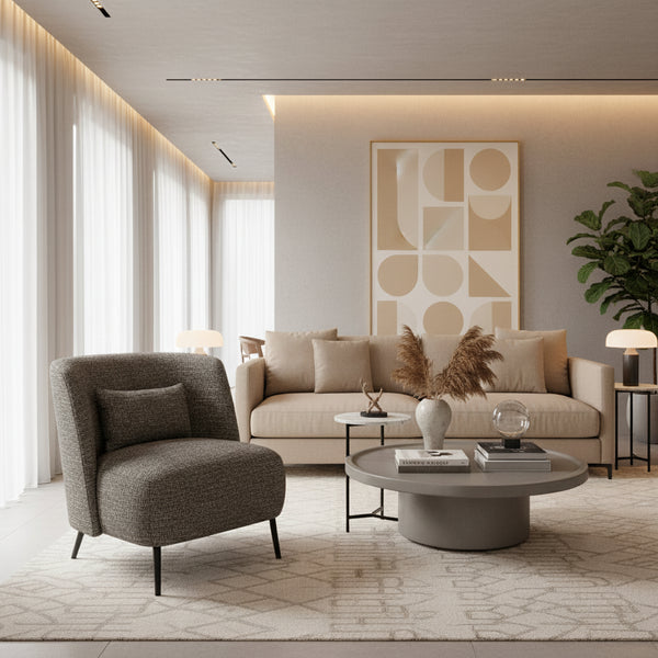 Gray armchair in a room with a plant and a small table.