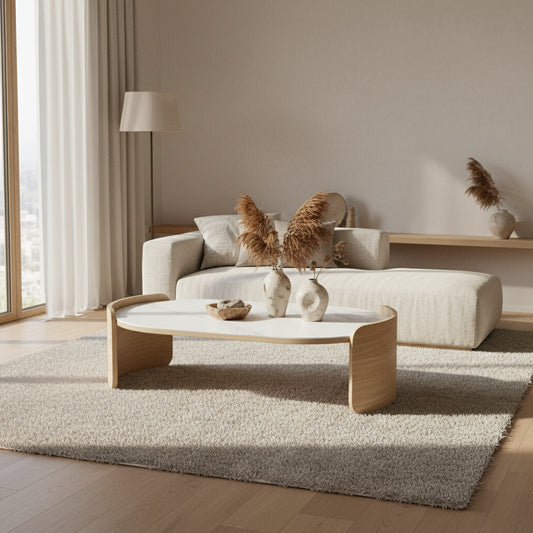 Modern living room with a beige sectional sofa and a decorative coffee table.