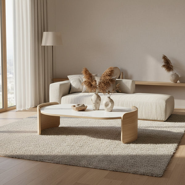 Modern living room with a beige sectional sofa and a decorative coffee table.