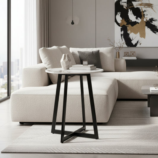Round side table with marble-like top and black metal legs on a white background