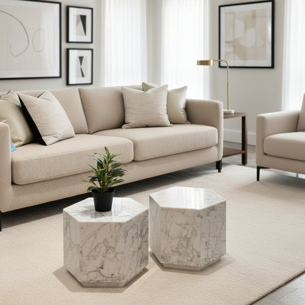 Hexagonal marble side tables with a plant on one of them in a living room setting.