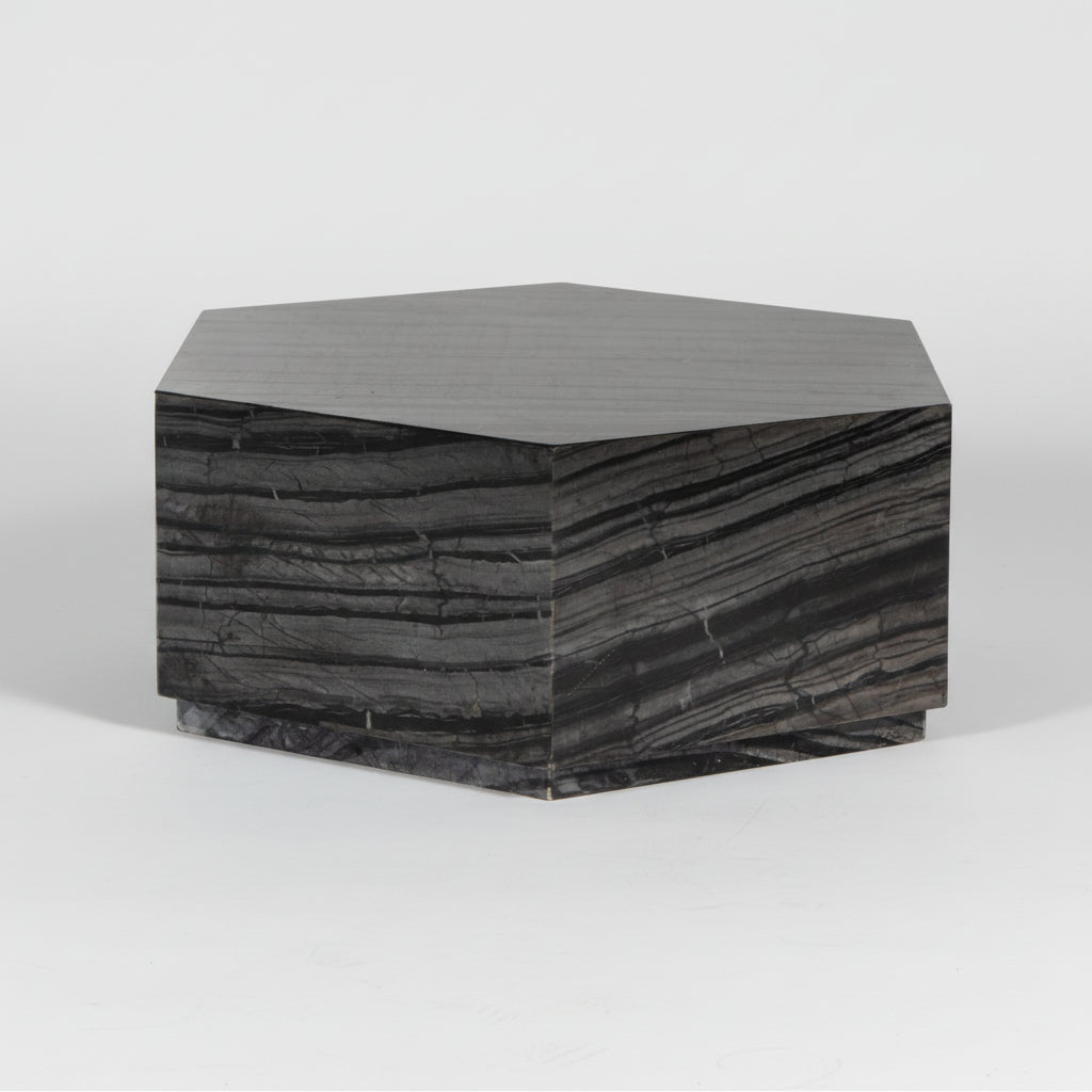 Hexagonal side table with a dark, textured surface on a white background
