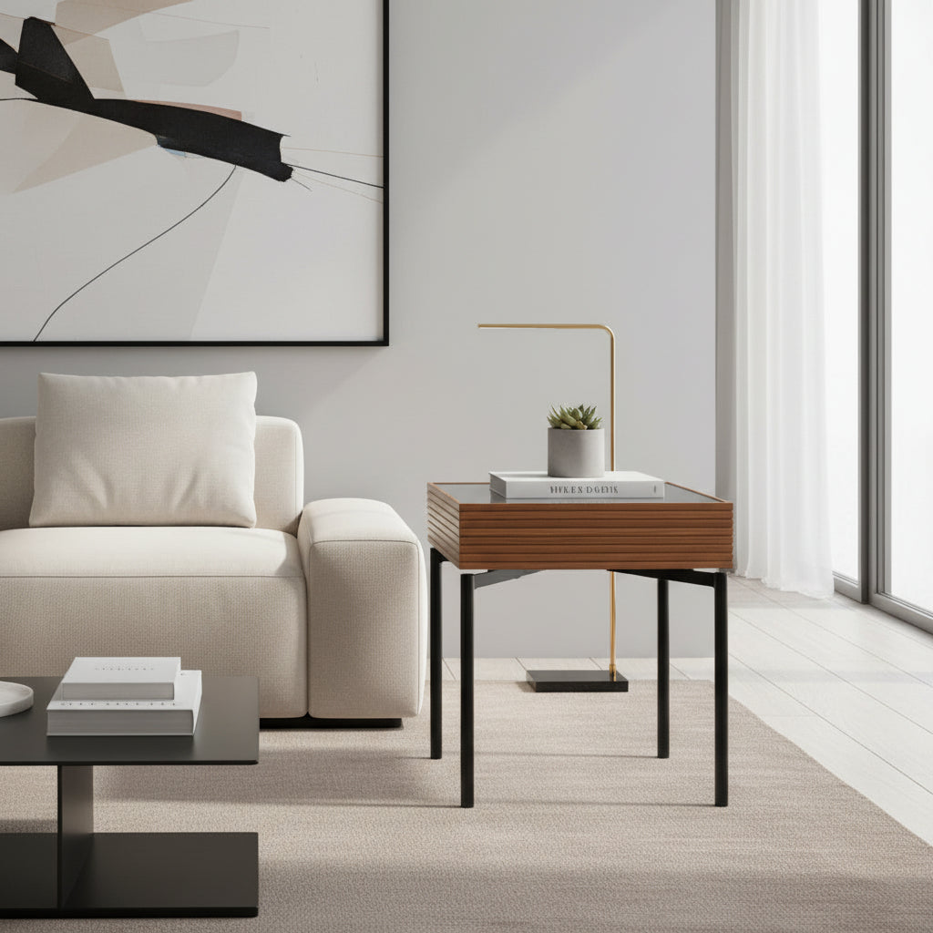 Two dark glass vases on a wooden side table in a living room setting.