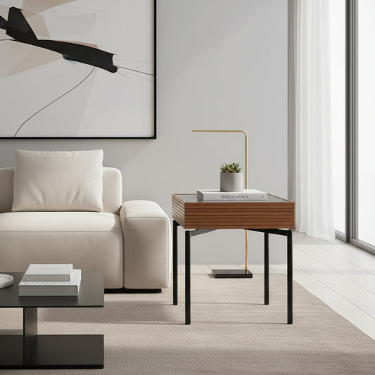 Two dark glass vases on a wooden side table in a living room setting.