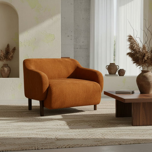 Orange armchair in a modern living room with wooden coffee table and decorative vases.